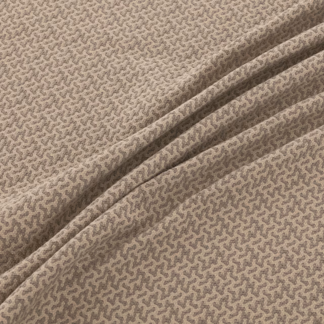 Taupe woven fabric with a small darker meandering motif and folded drape
