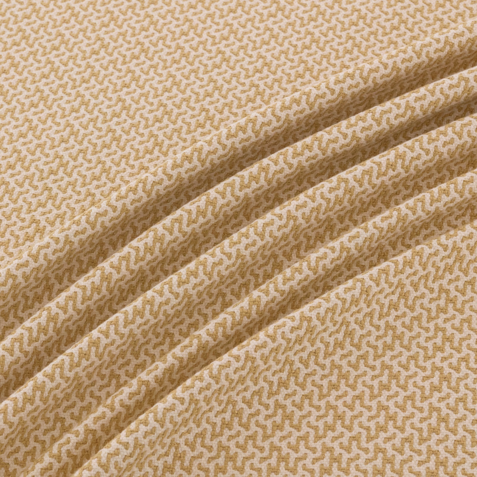 Warm sandy-tan woven textile with a cream meandering micro-pattern and folded texture