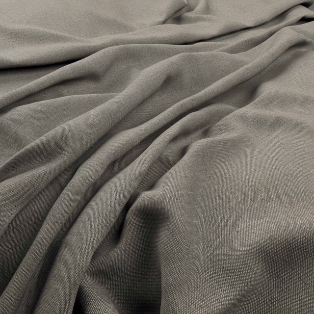 Warm greige fine weave fabric draped in soft, shadowed folds