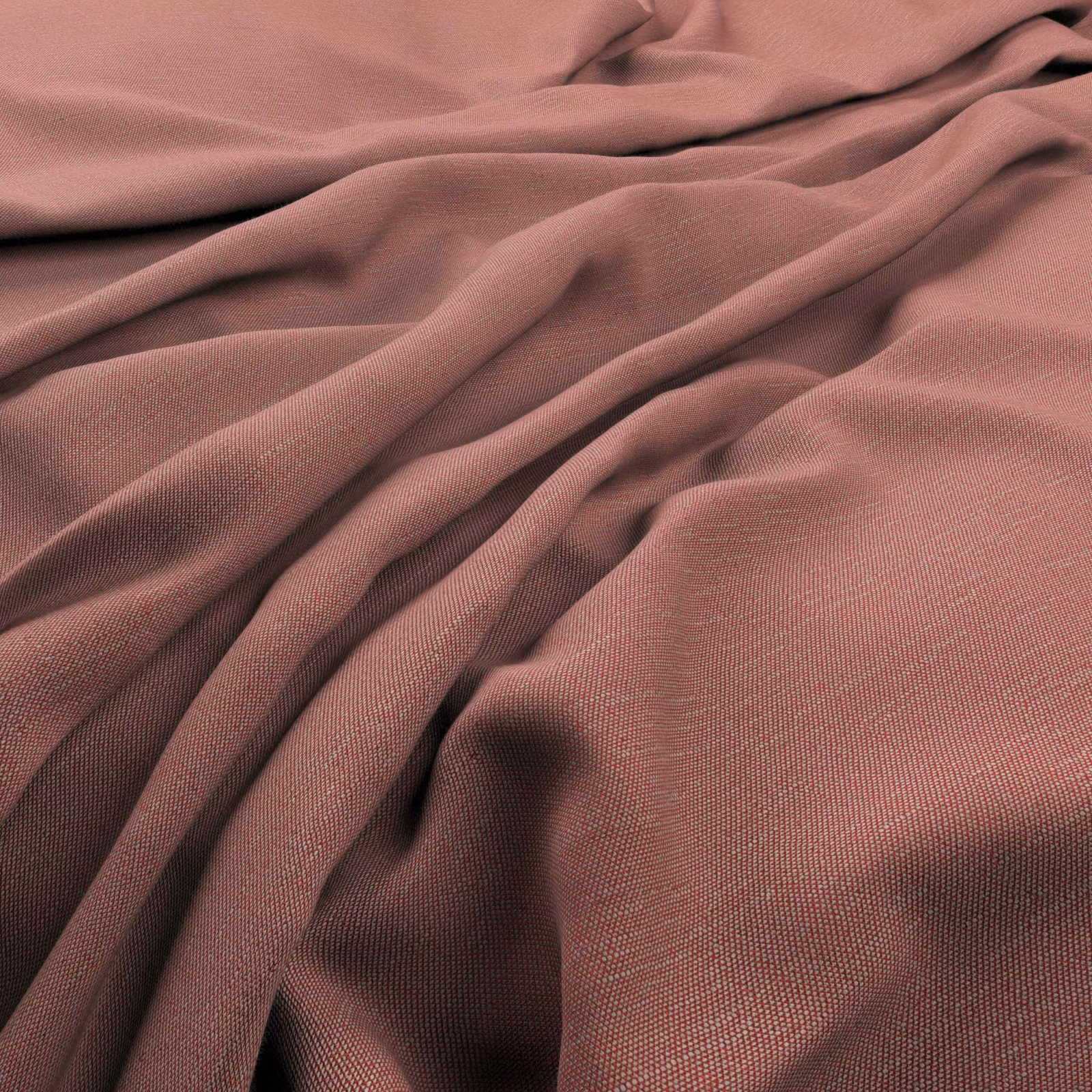 Close-up of muted coral-rose fabric with a fine plain weave and fluid folds