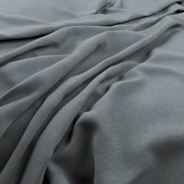 Muted blue-grey Husk textile gathered into soft folds with a fine even weave