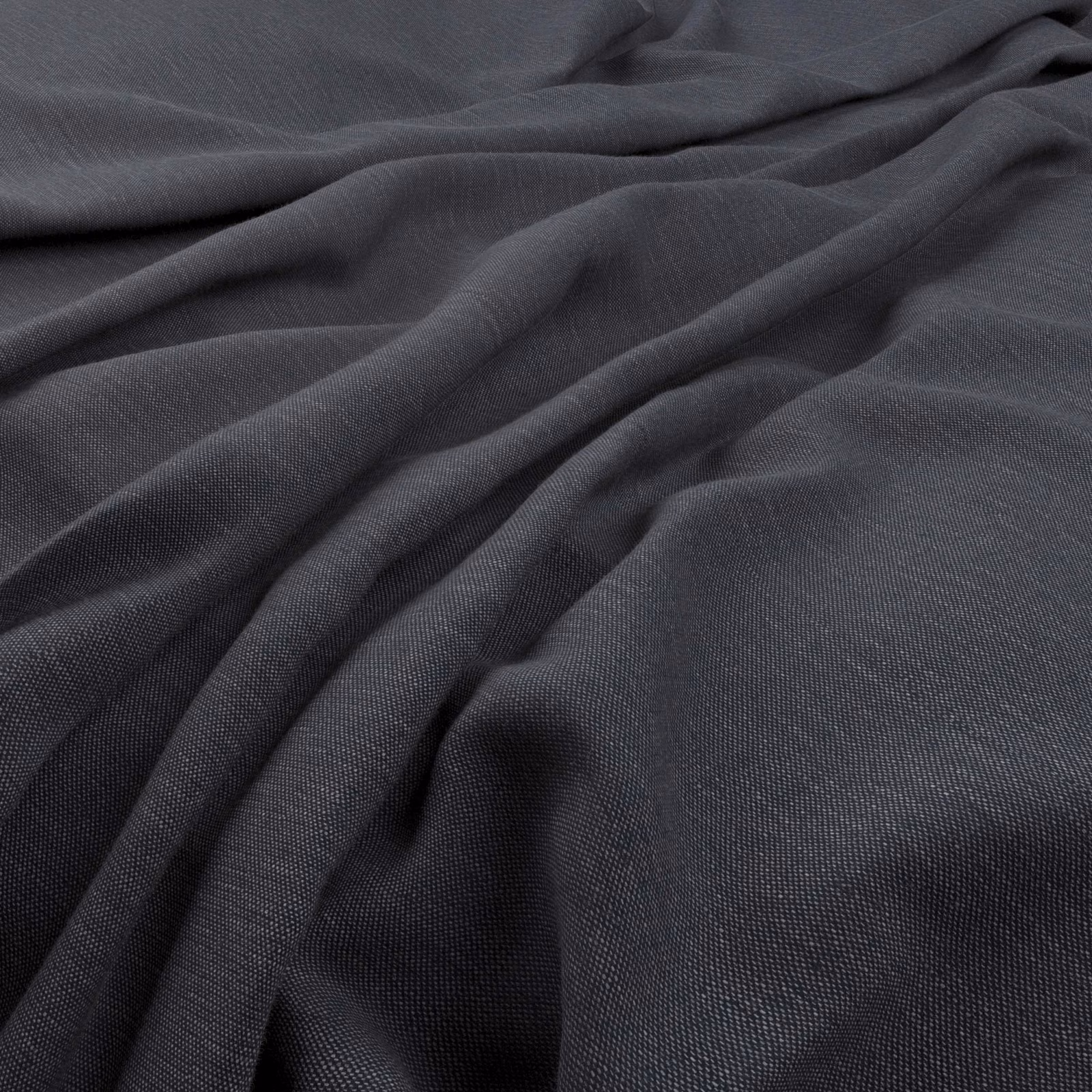 Deep charcoal indigo fabric with a fine weave falling in soft fluid folds
