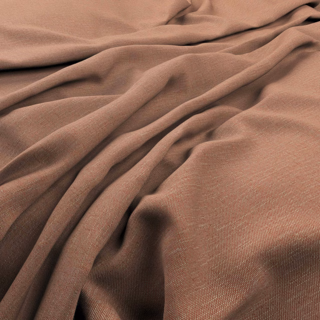 Close-up of muted papaya-brown plain woven fabric gathered into soft folds