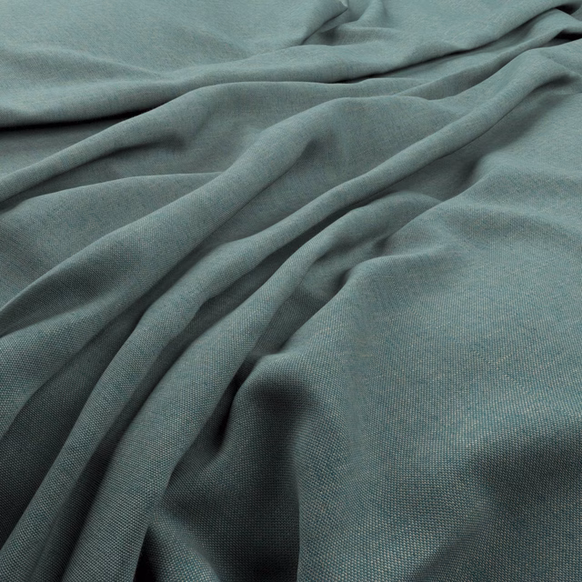 Muted turquoise woven fabric gathered into soft, fluid folds with a fine surface texture