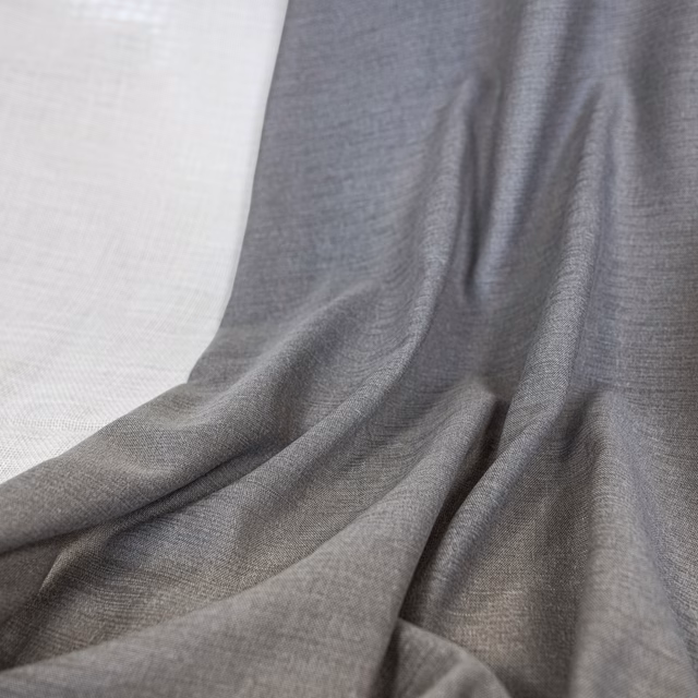 Cool mid-grey woven fabric gathered into softly rippled, fluid folds