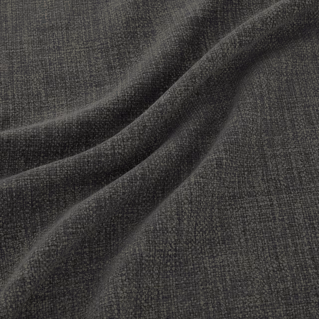 Close-up of charcoal-grey woven fabric with fine peppered texture and soft folds