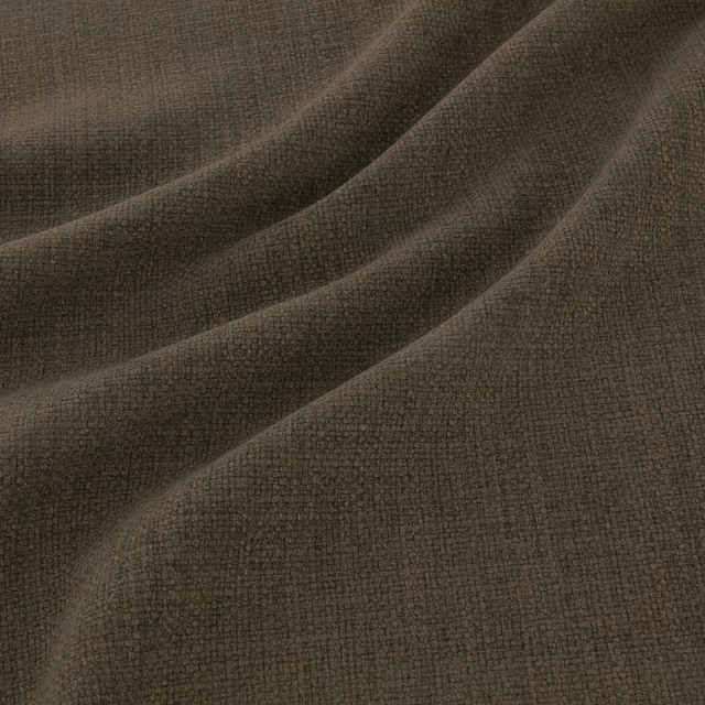 Dark pine-green woven textile with fine pebbled texture in soft folds