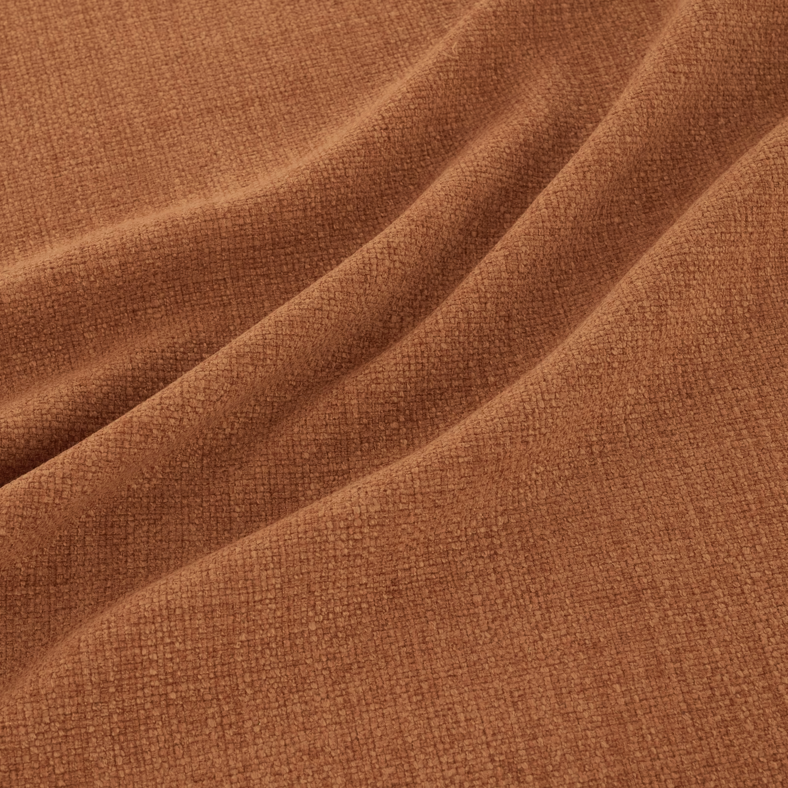Warm pumpkin terracotta crosshatch weave falling into broad, softly shaded folds