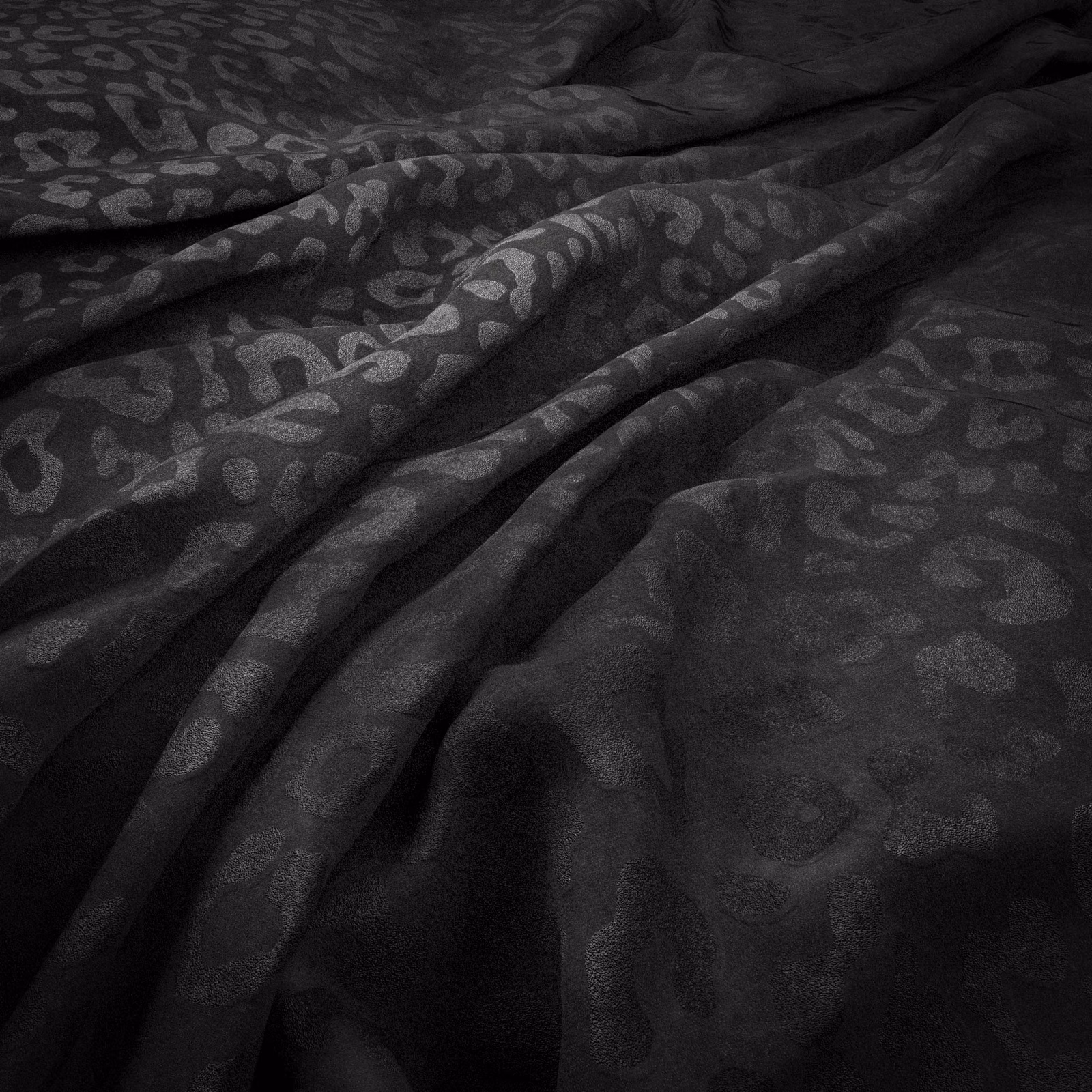 Near-black Jaguar fabric with charcoal animal spots and soft draped sheen