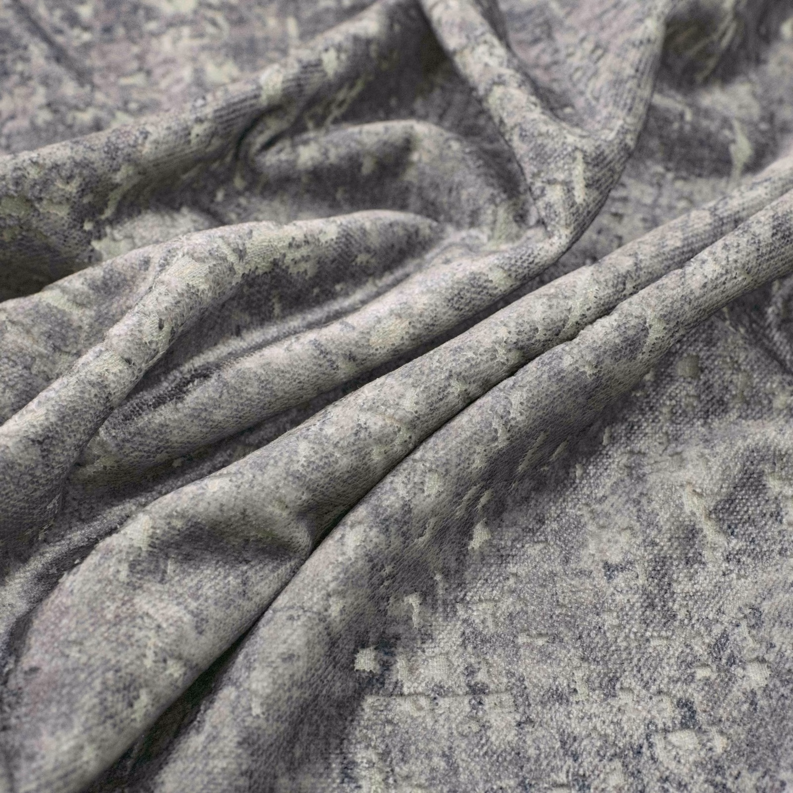 Cool aluminium-grey fabric with cloudy mottling, fine texture and softly folded drape