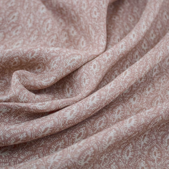 Dusty blush-pink fabric with ivory paisley motifs gathered into soft folds