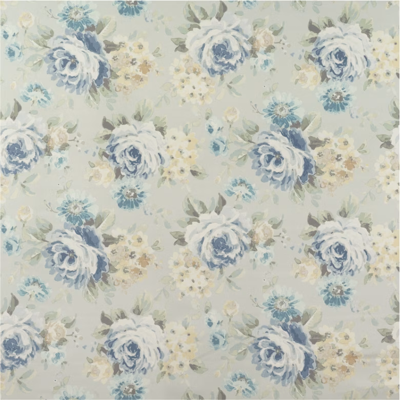 Pale celadon fabric with painterly blue roses, cream flowers and leafy sprays