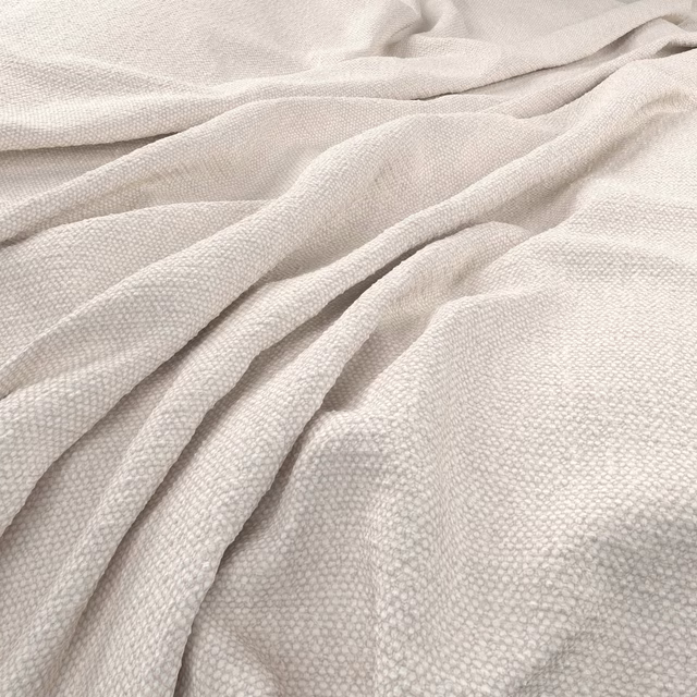 Pale chalk cream woven fabric with a small-scale pebbled texture and soft folds