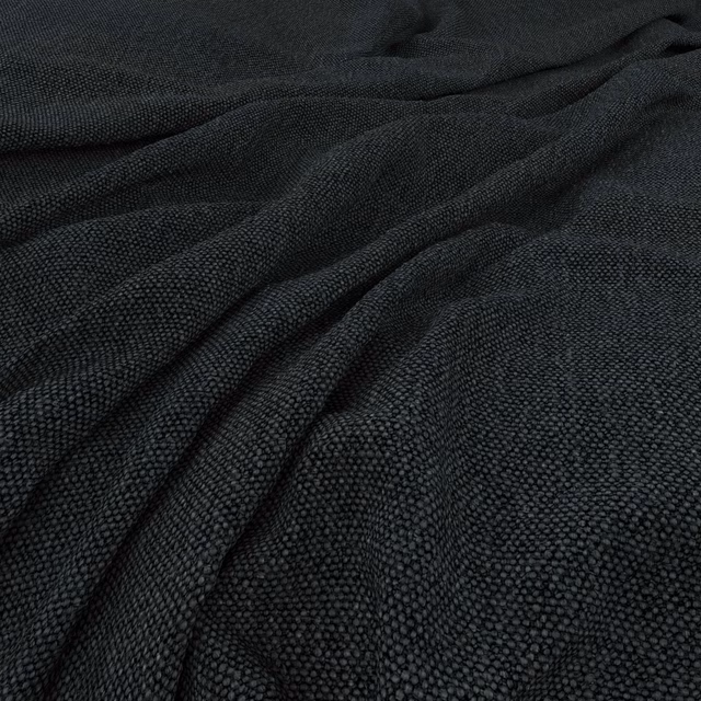 Charcoal-black woven textile with a fine pebbled texture gathered into soft folds