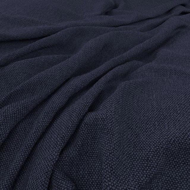 Deep indigo fabric with a finely pebbled weave draped into soft folds