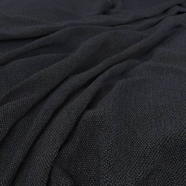 Dark charcoal-black pebbled upholstery weave gathered into soft, shadowed folds