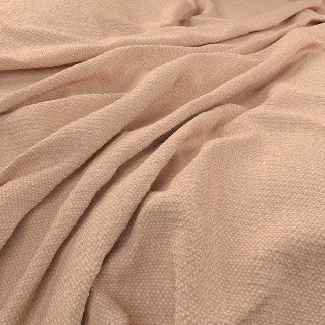 Warm blush-nude woven fabric with a small raised texture draped in soft folds