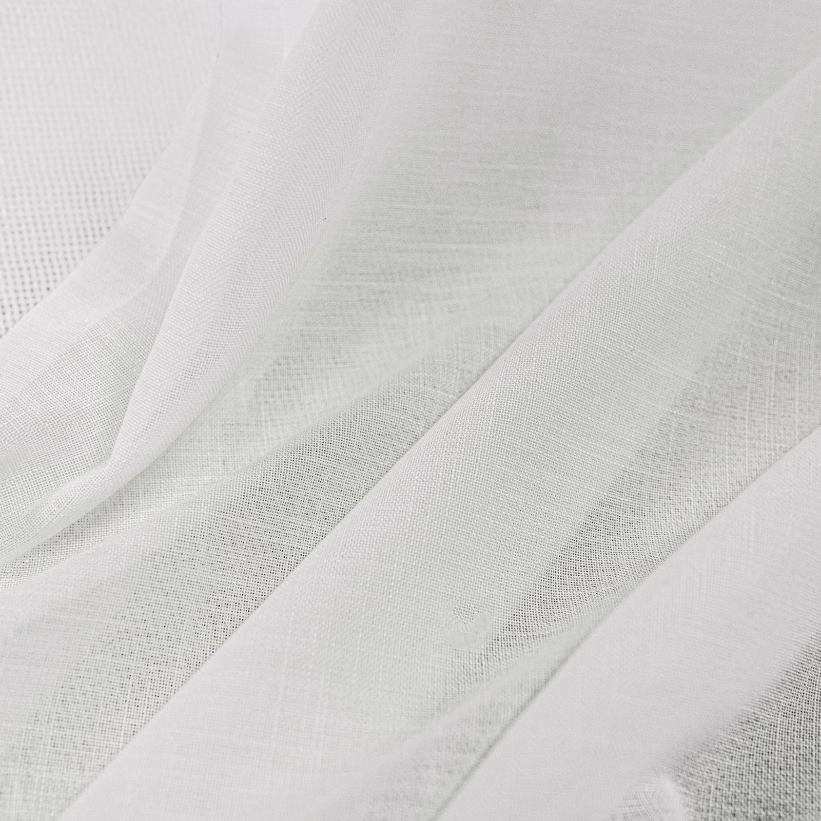 Ivory woven textile draped in folds, showing fine open texture and soft translucency