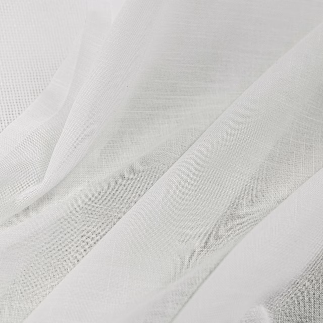 Ivory woven textile draped in folds, showing fine open texture and soft translucency