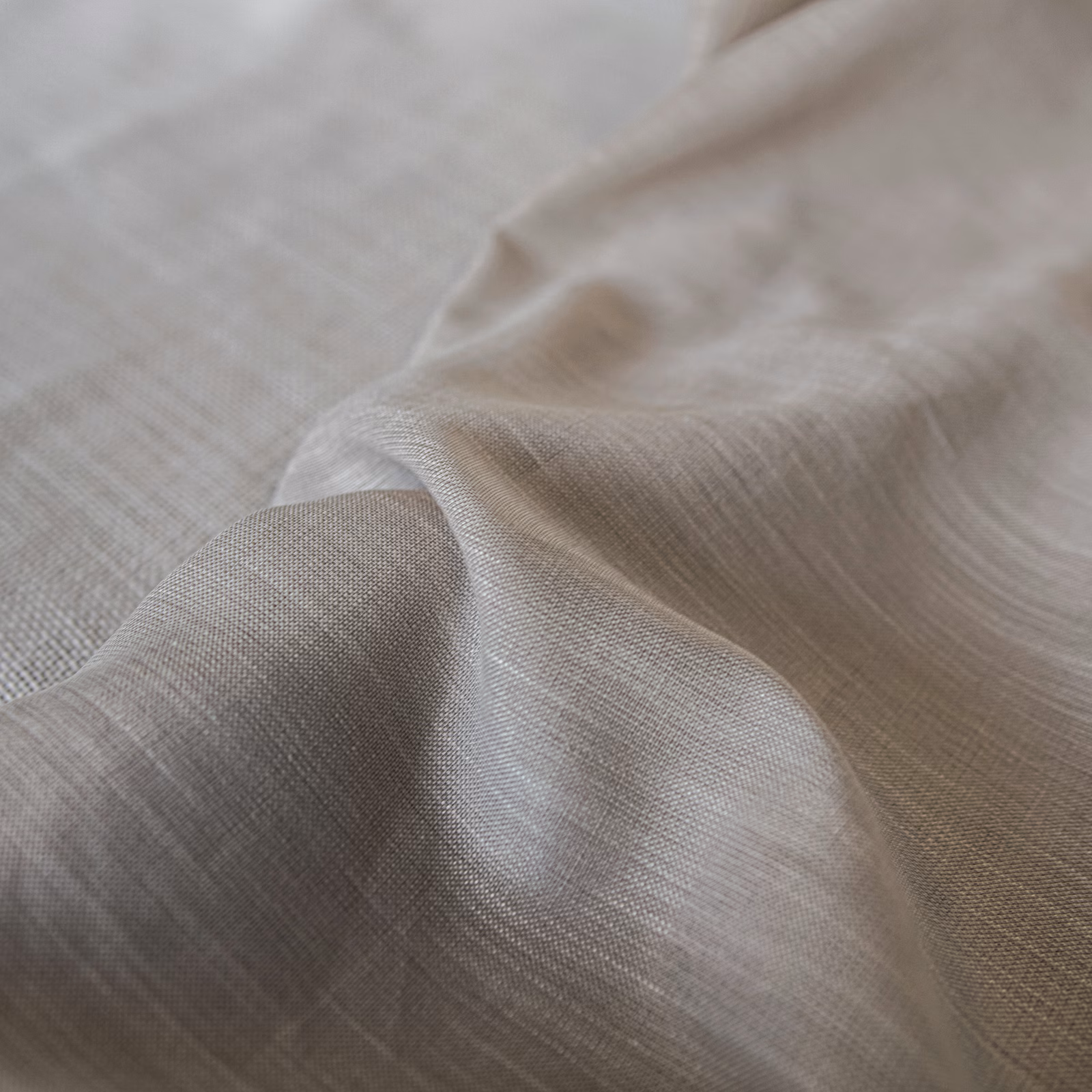 Warm natural taupe fabric with a fine grid weave gathered into soft folds