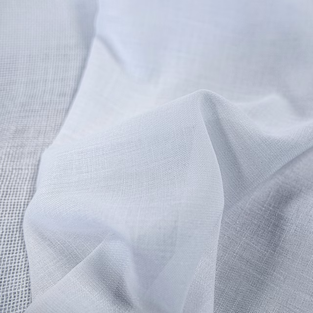 Pale blue-grey fine plain weave fabric folded to show a soft translucent texture