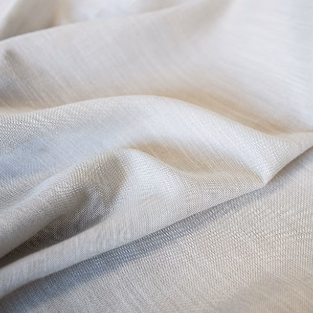 Light oyster woven textile with fine crosshatch texture in soft folded waves