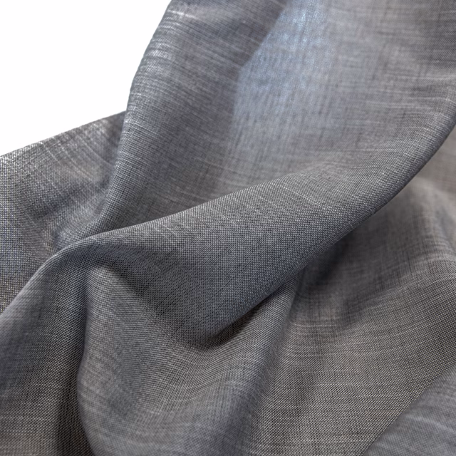Smoke-grey woven cloth forming soft folds with a subtle crosshatched surface