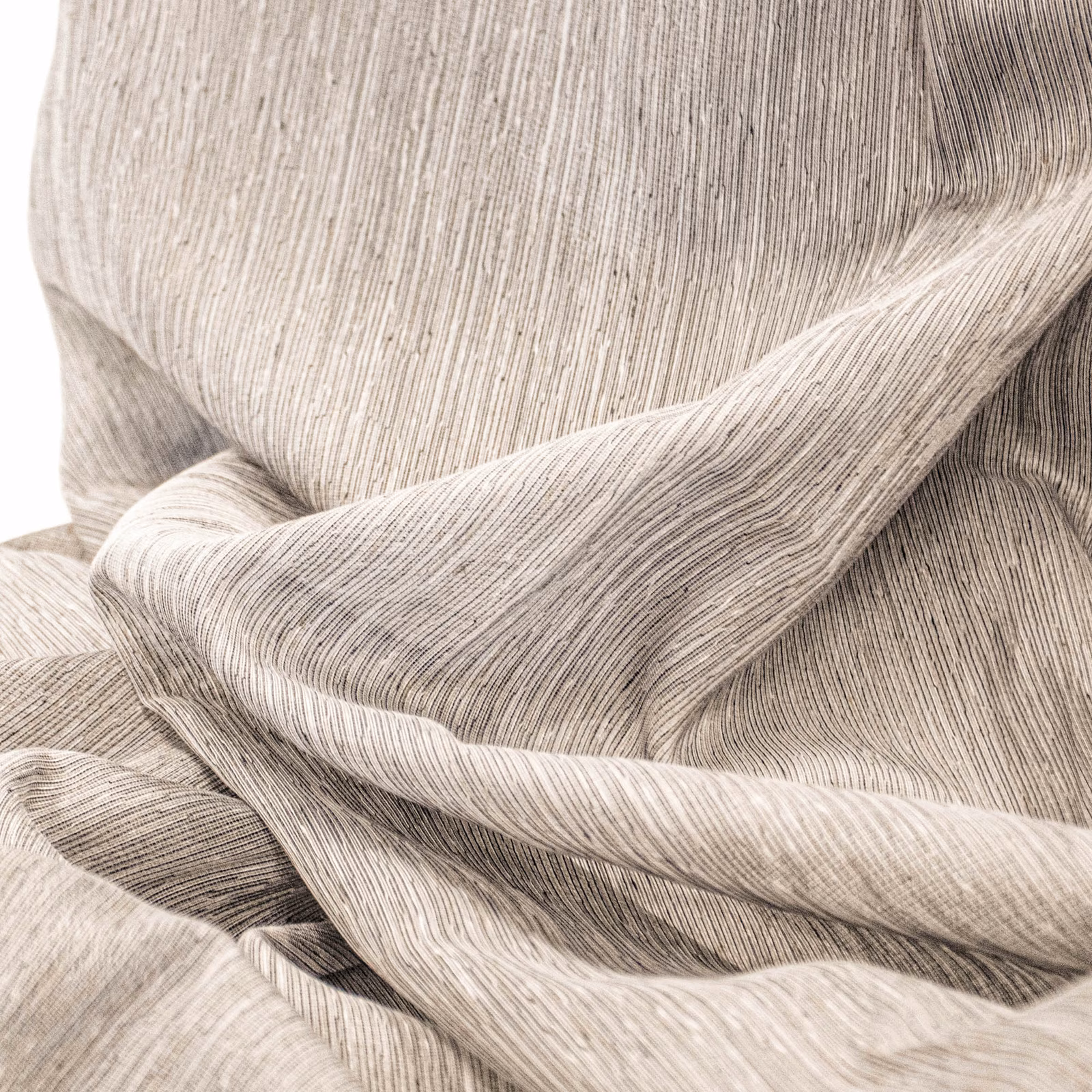 Warm cream textile with fine vertical striations folded into flowing layered drapes