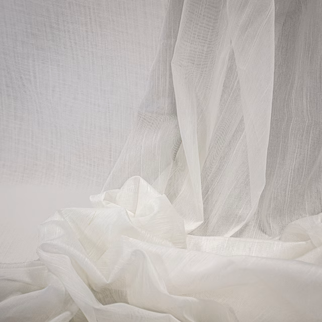 Warm ivory sheer fabric with fine open weave gathered in soft translucent folds