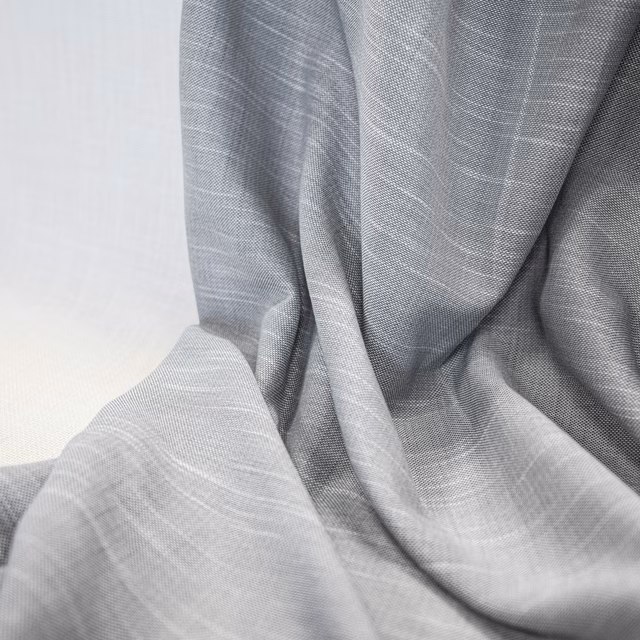 Fluid ash-grey cloth with fine woven lines folding into silvery and graphite shadows