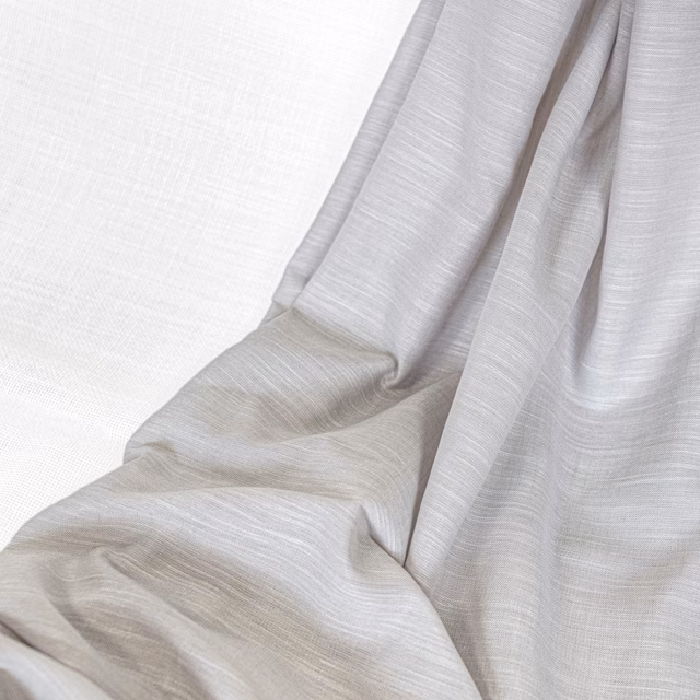 Gathered ivory-grey fabric showing fine horizontal slubs and softly fluid folds