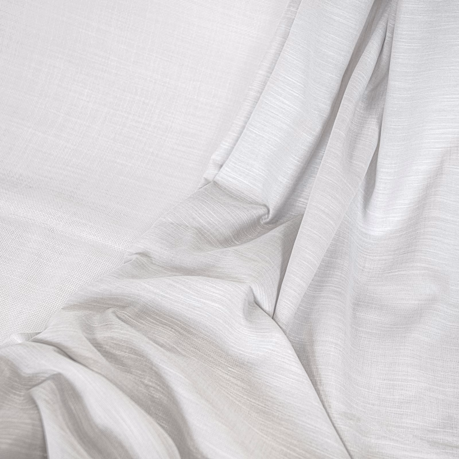 Soft optic-white textile with fine horizontal weave falling in fluid rippled folds
