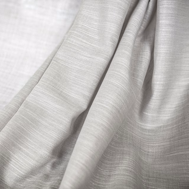 Pale oyster-grey fabric with fine horizontal weave falling in soft fluid folds