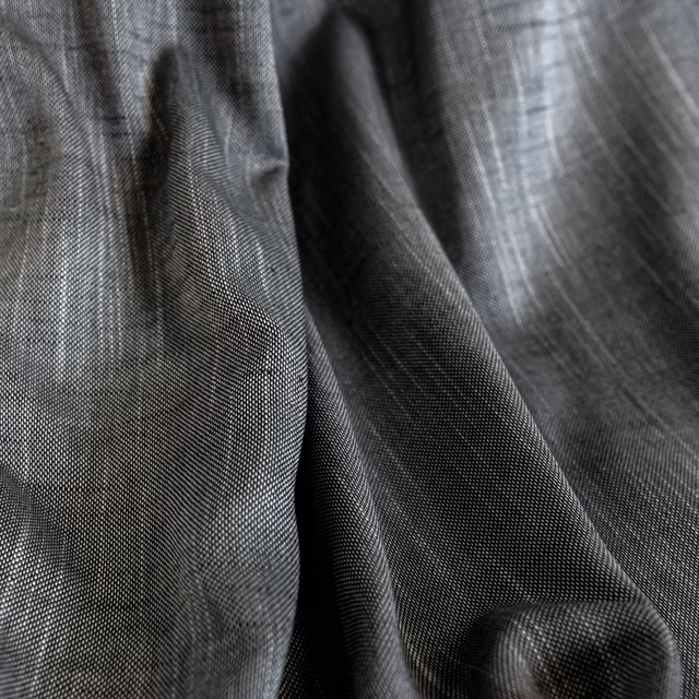 Close-up of charcoal smoke-grey fabric showing fine woven texture and soft folds