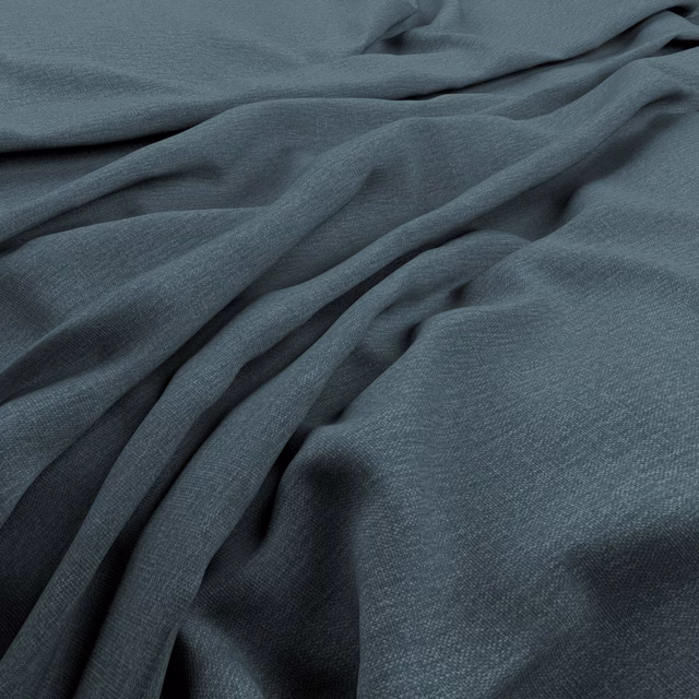 Cool blue-grey woven cloth in soft folds, showing a fine, lightly textured grain