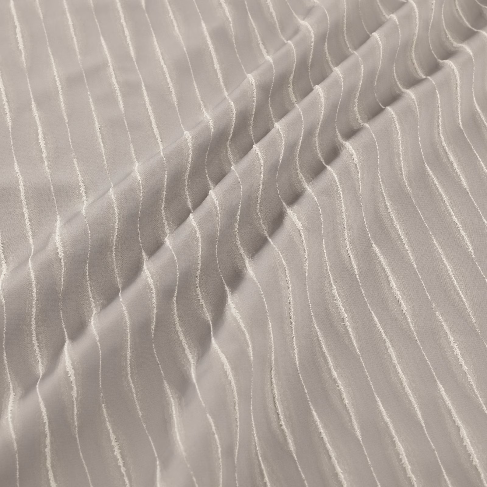 Iron-grey fabric with raised, irregular pale waves and soft gathered folds