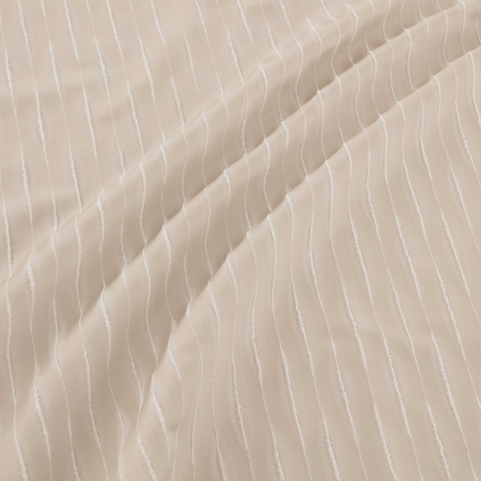 Warm ivory beige fabric with fine irregular white vertical lines and fluid folds
