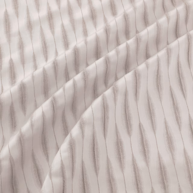 Pale silver fabric with softly raised, irregular vertical grey stripes in folded drape
