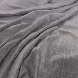 Cool lead-grey fabric with a fine crosshatched weave falling in soft folds