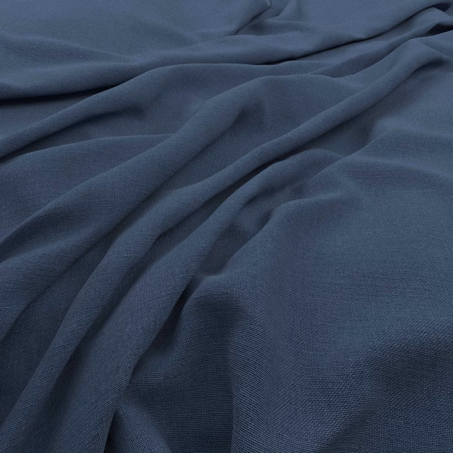 Deep airforce-blue plain-weave fabric gathered into soft, fluid folds