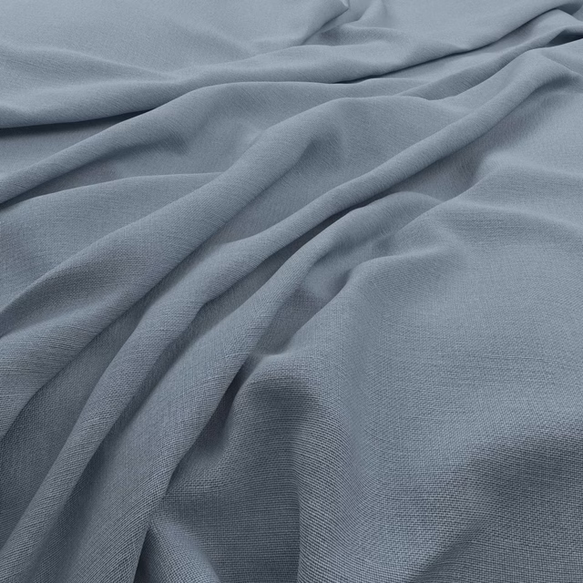 Powder blue-grey Koki fabric showing a fine plain weave in soft flowing folds