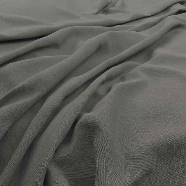 Close view of Koki Stone’s cool grey fine weave falling into soft folds