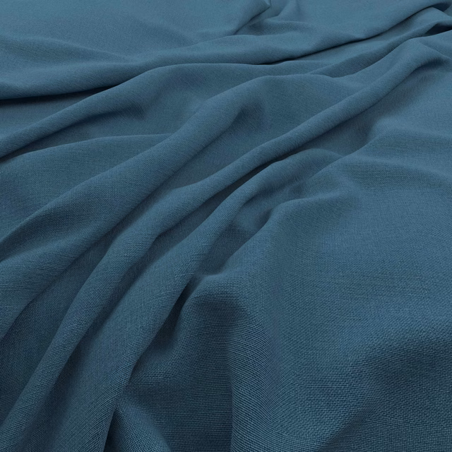 Close view of cool deep teal fabric with fine weave and soft gathered folds