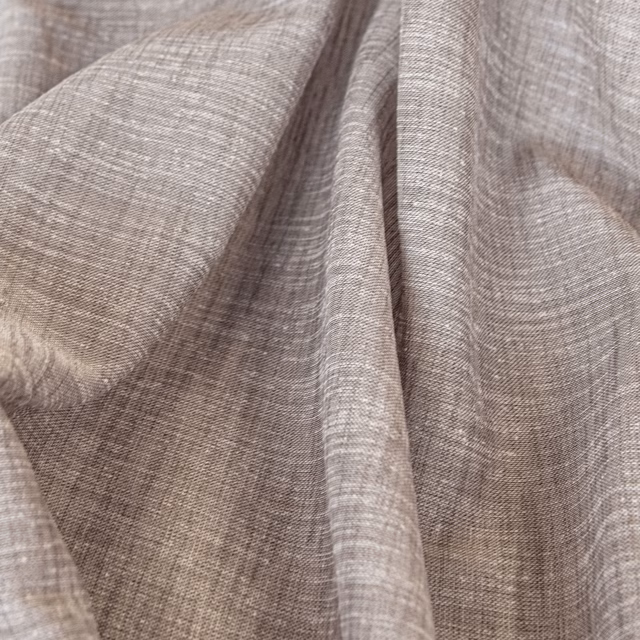 Soft taupe Kos fabric showing fine slubbed weave gathered into fluid folds