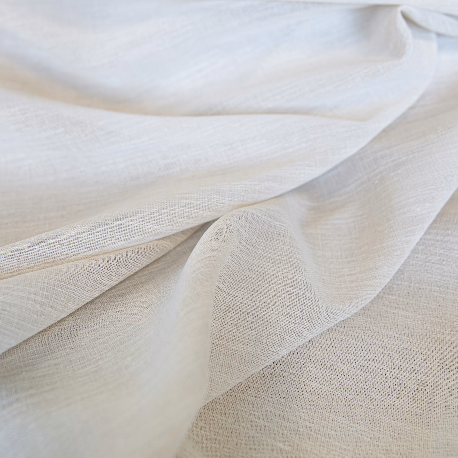 Layered ivory fabric with a fine open weave, subtle texture and soft flowing folds
