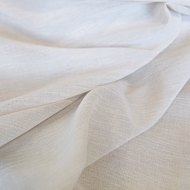 Layered ivory fabric with a fine open weave, subtle texture and soft flowing folds
