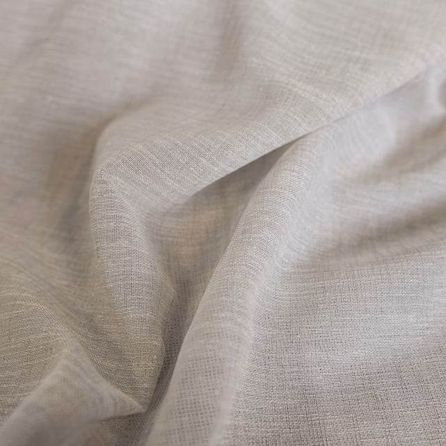 Soft natural greige woven cloth in close-up, showing fine open texture and folds.