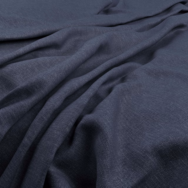 Deep indigo plain weave fabric gathered into soft, shadowed folds with fine texture