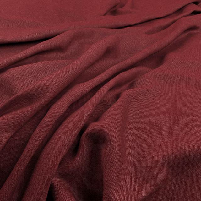 Deep pomegranate-red plain weave fabric gathered into textured folds with burgundy shadows