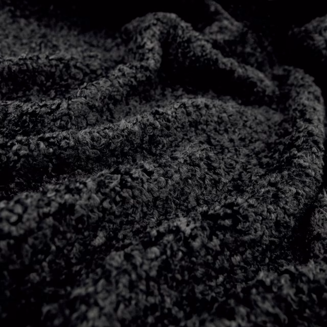 Near-black Lambert textile with charcoal looped pile and deep folded texture